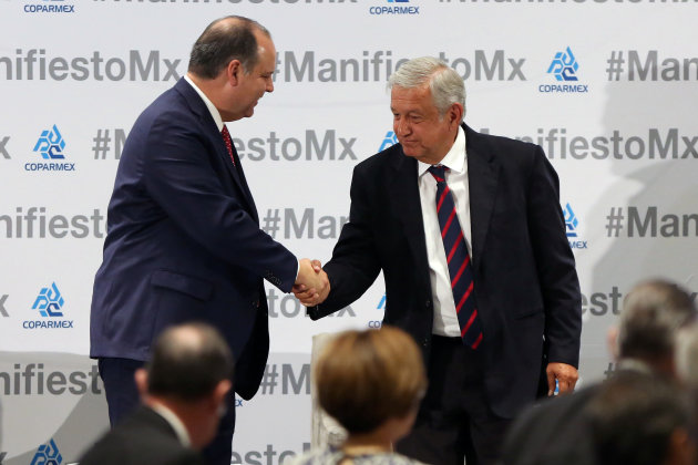 Leftist front-runner Andres Manuel Lopez Obrador shakes hands with Gustavo de Hoyos, president of COPARMEX, during an event organised by COPARMEX in Mexico City